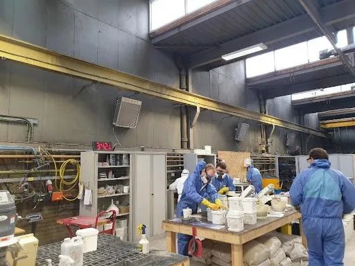 four workers working under a x-heat nano-heater that isn't turned on.
