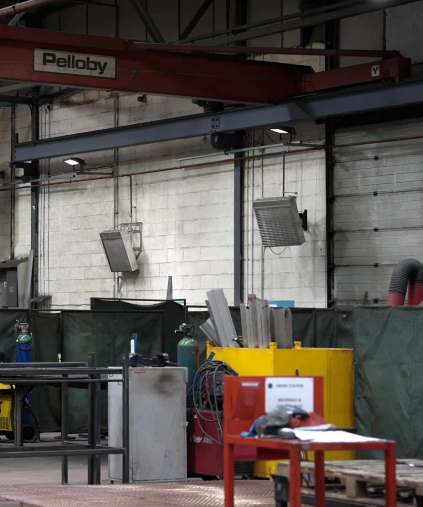 a picture of a warehouse with two nano-heaters on the back wall, which is a brick wall that's painted white.