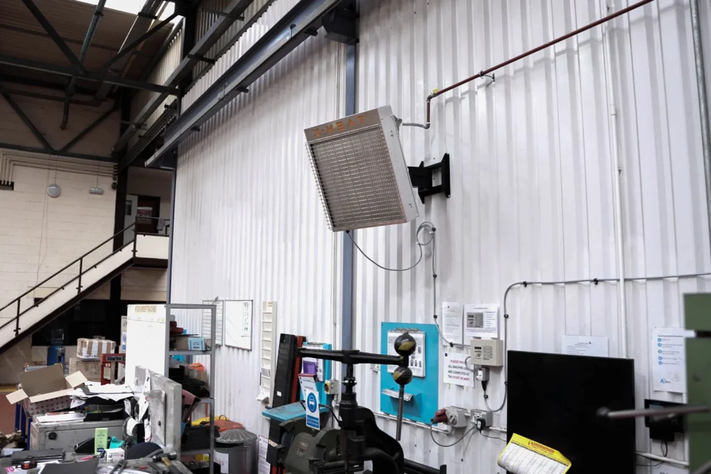 a nano-heater mounted onto a white wall in a warehouse