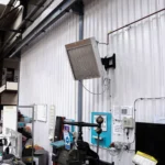 a nano-heater mounted onto a white wall in a warehouse
