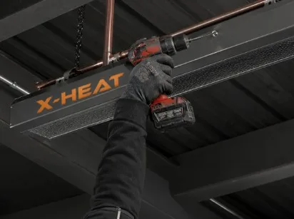 a worker installing the X-Heat Nano-Heat²⁴ onto a ceiling